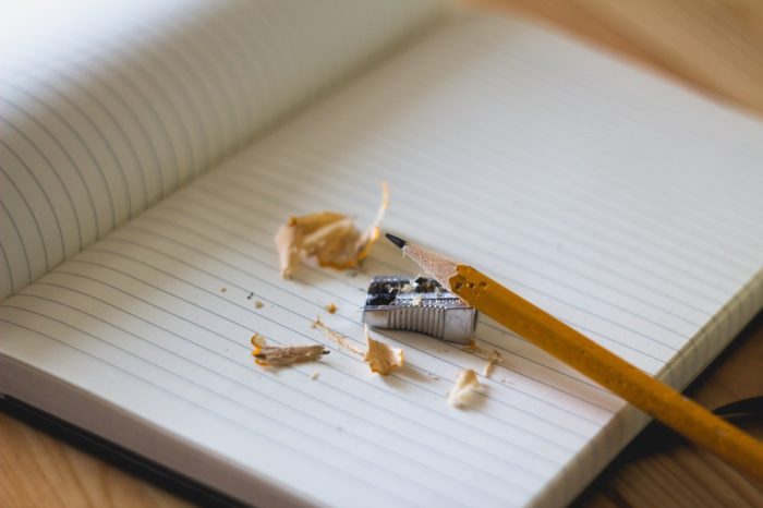 Pencil, pencil sharpener and notebook, symbolising the concept of personal development habits