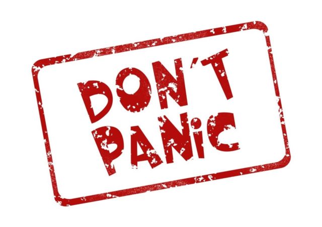 Phrase "DON'T PANIC" representing the effective mindset of dealing with debt.