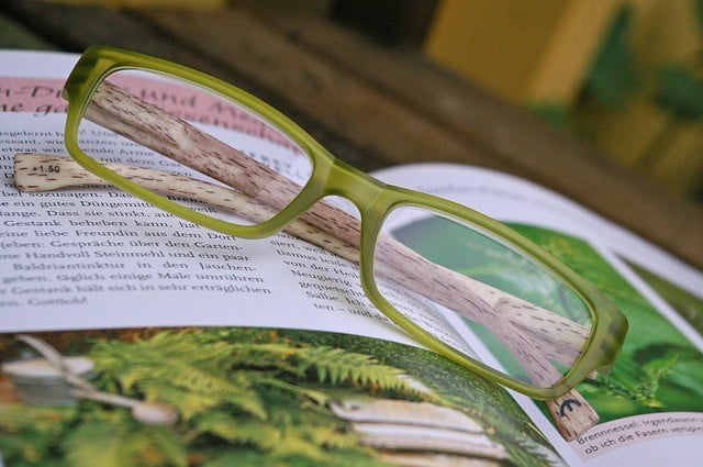 A pair of glasses and book representing habits to become a better person