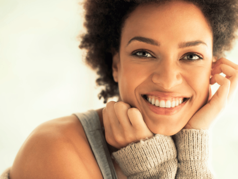 Smiling woman representing positive change, related to improving yourself in 30 days