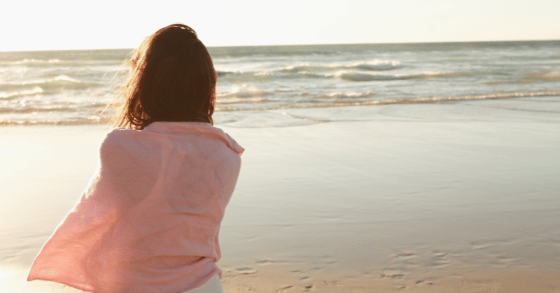 Woman looking at ocean, contemplating important life lessons