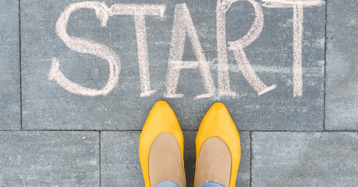 Word "START" on asphalt and woman feet, symbolising it's never too late to start over