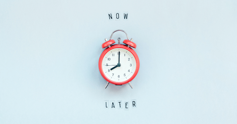 Alarm clock and words "NOW" and "LATER," depicting the concept of time-wasting activities