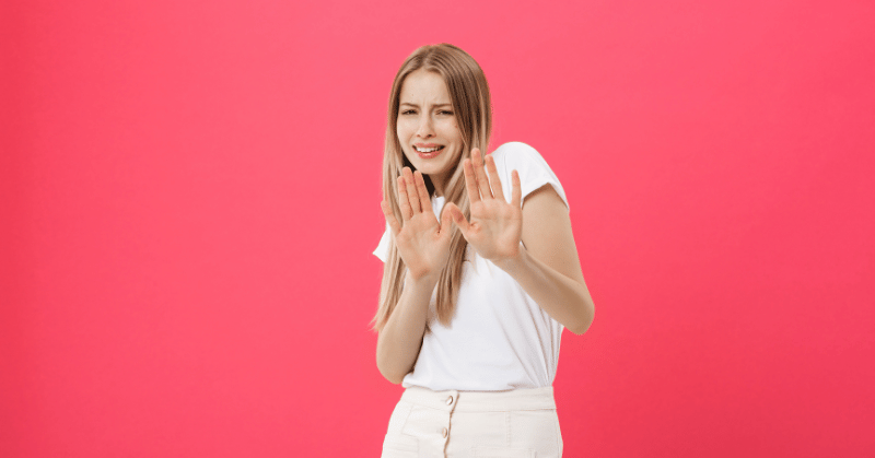 Woman with refusal gesture, depicting overcoming temptations during the no spend challenge